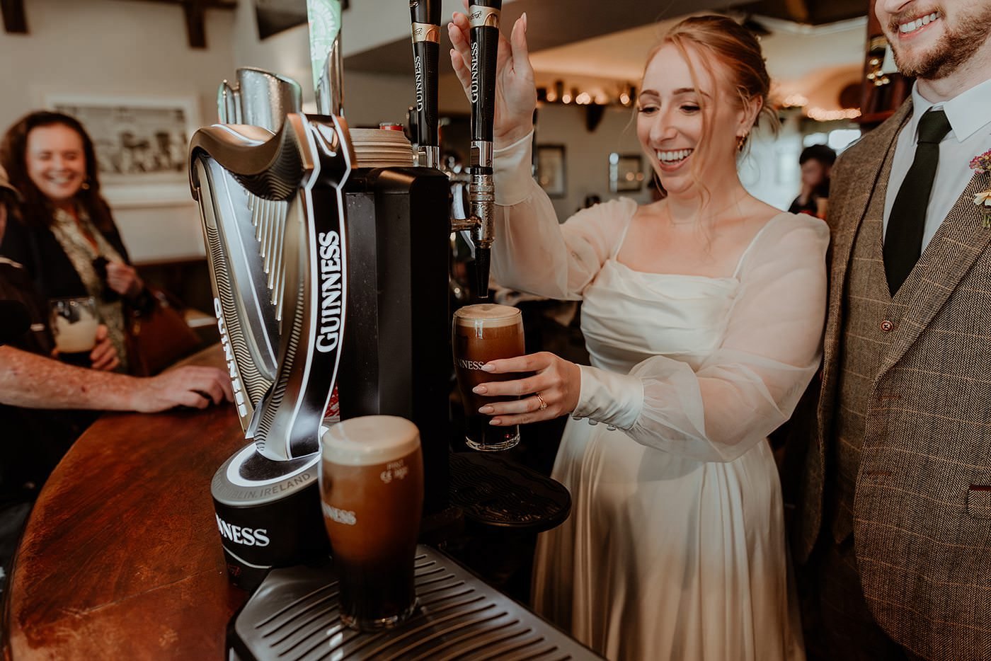 Guinness Pint Pouring in Irish Pub Destination Elopement Wedding in Ireland