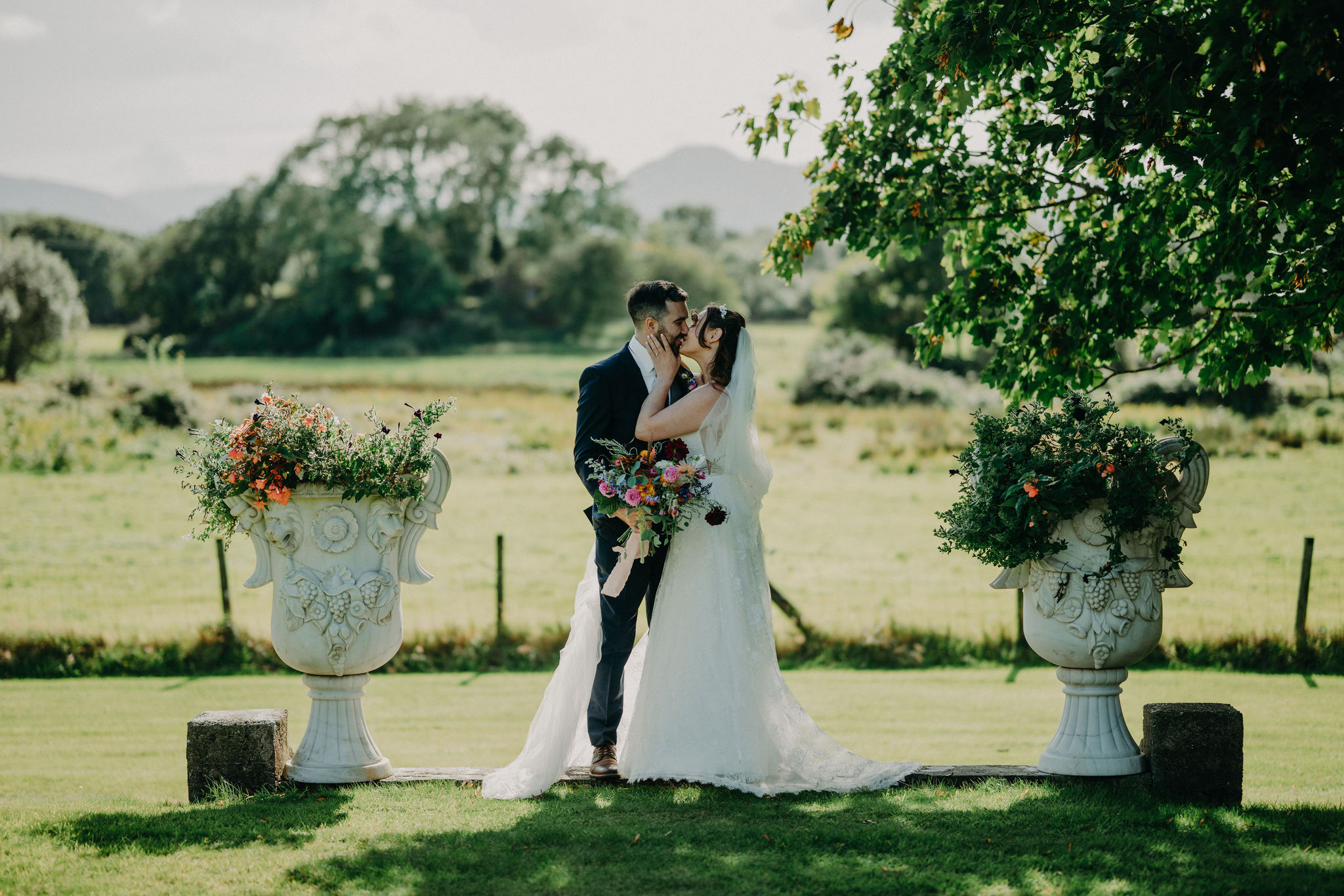 Bride and groom kissing during luxury garden elopement at Cahernane House in Killarney, Ireland