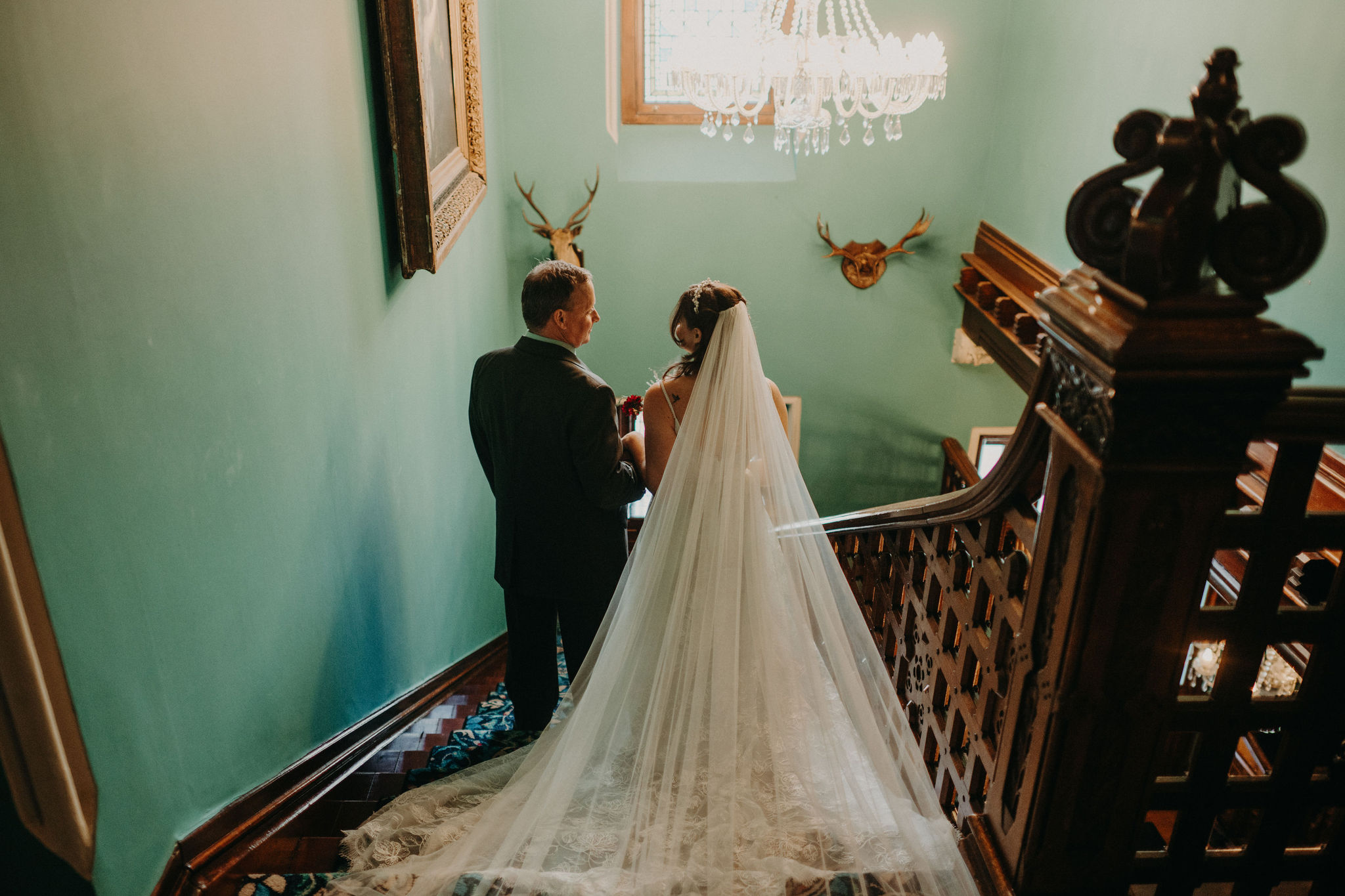 Bride walking downstairs with long veil before destination wedding at Cahernane House Ireland