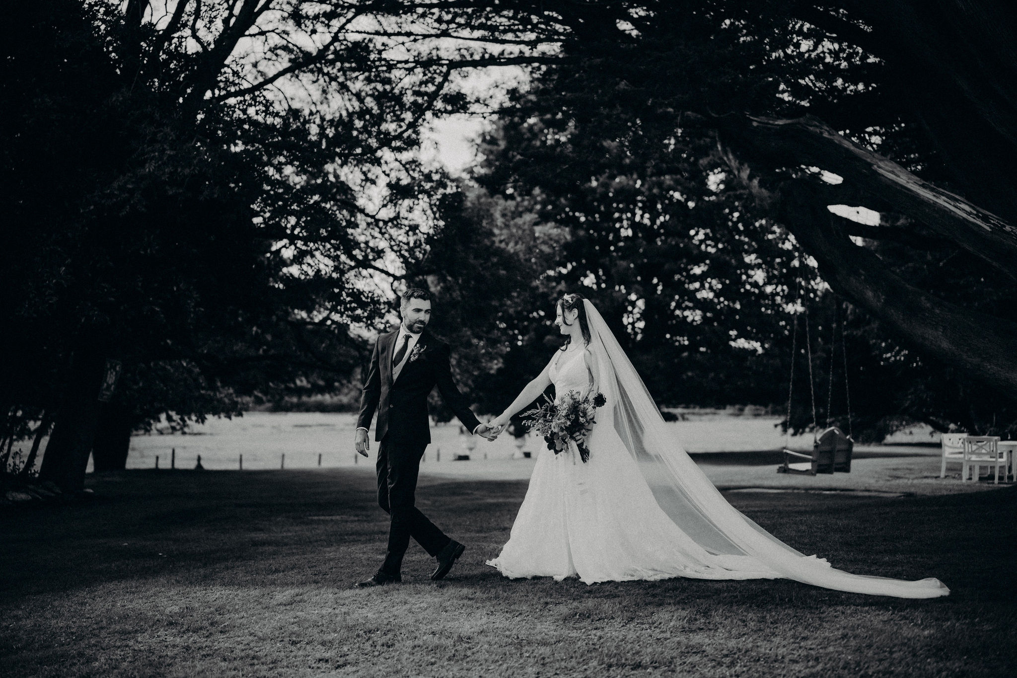 Black and white portrait of couple walking at Cahernane House elopement