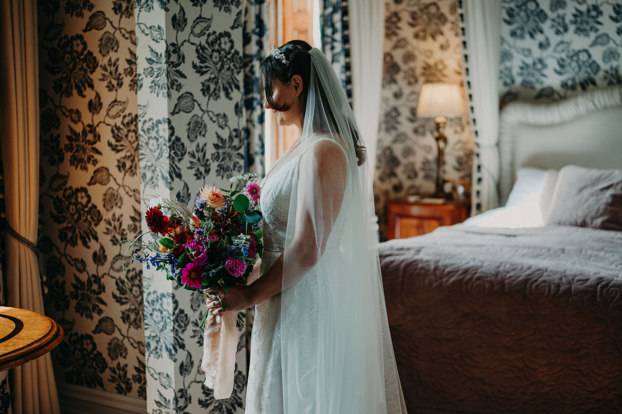 Bride holding colorful bouquet in Cahernane House suite