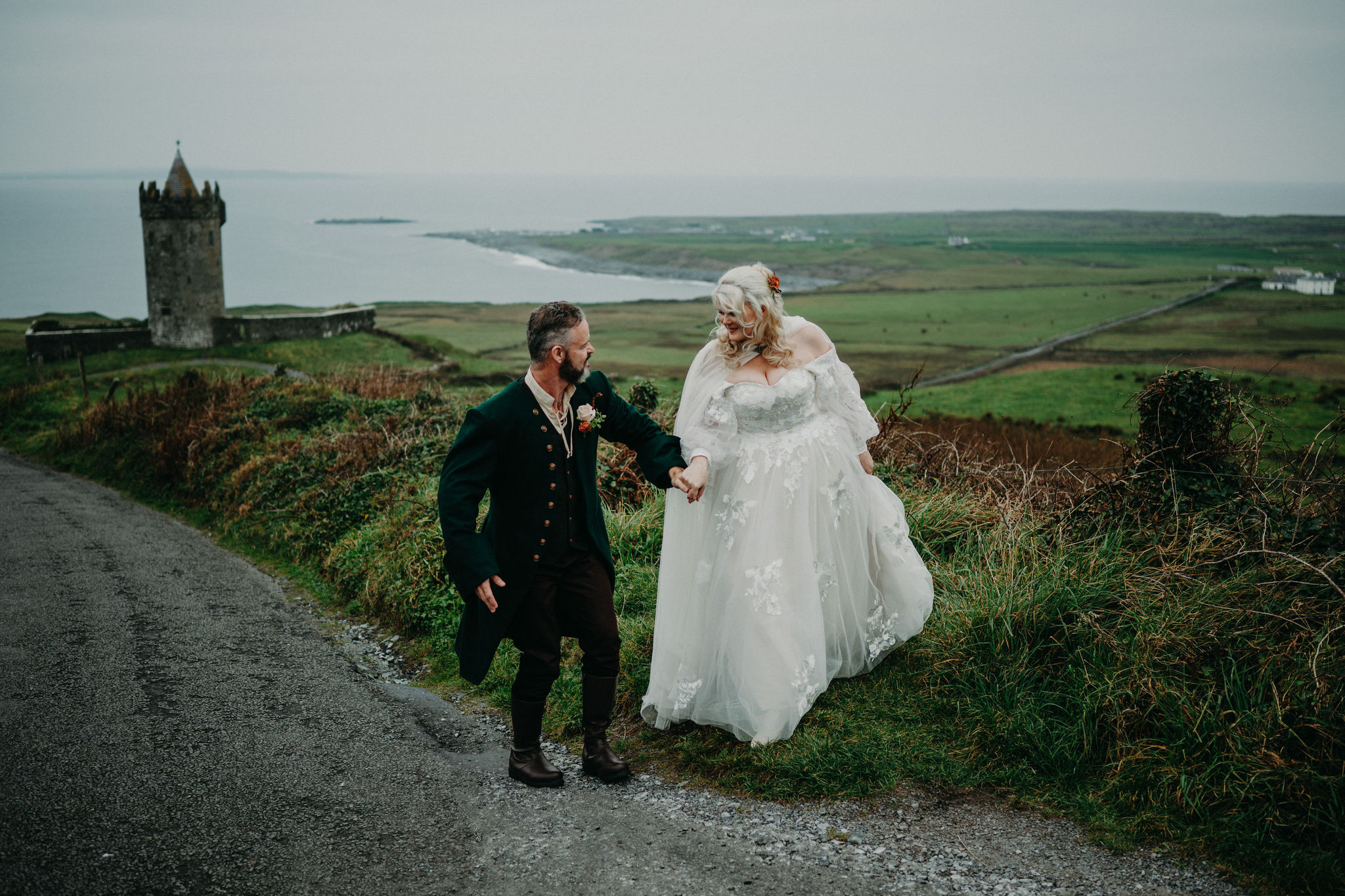 Newlywed couple beside Doonagore Castle during an Ireland elopement wedding.