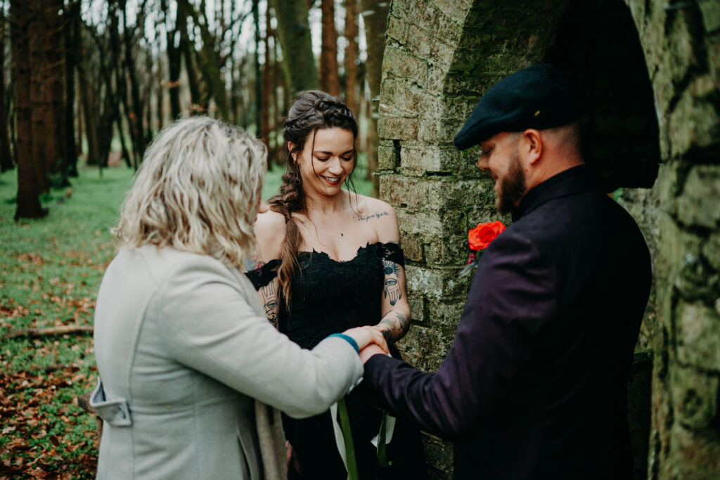 Couple exchanging rings during a woodland chapel elopement ceremony in Ireland