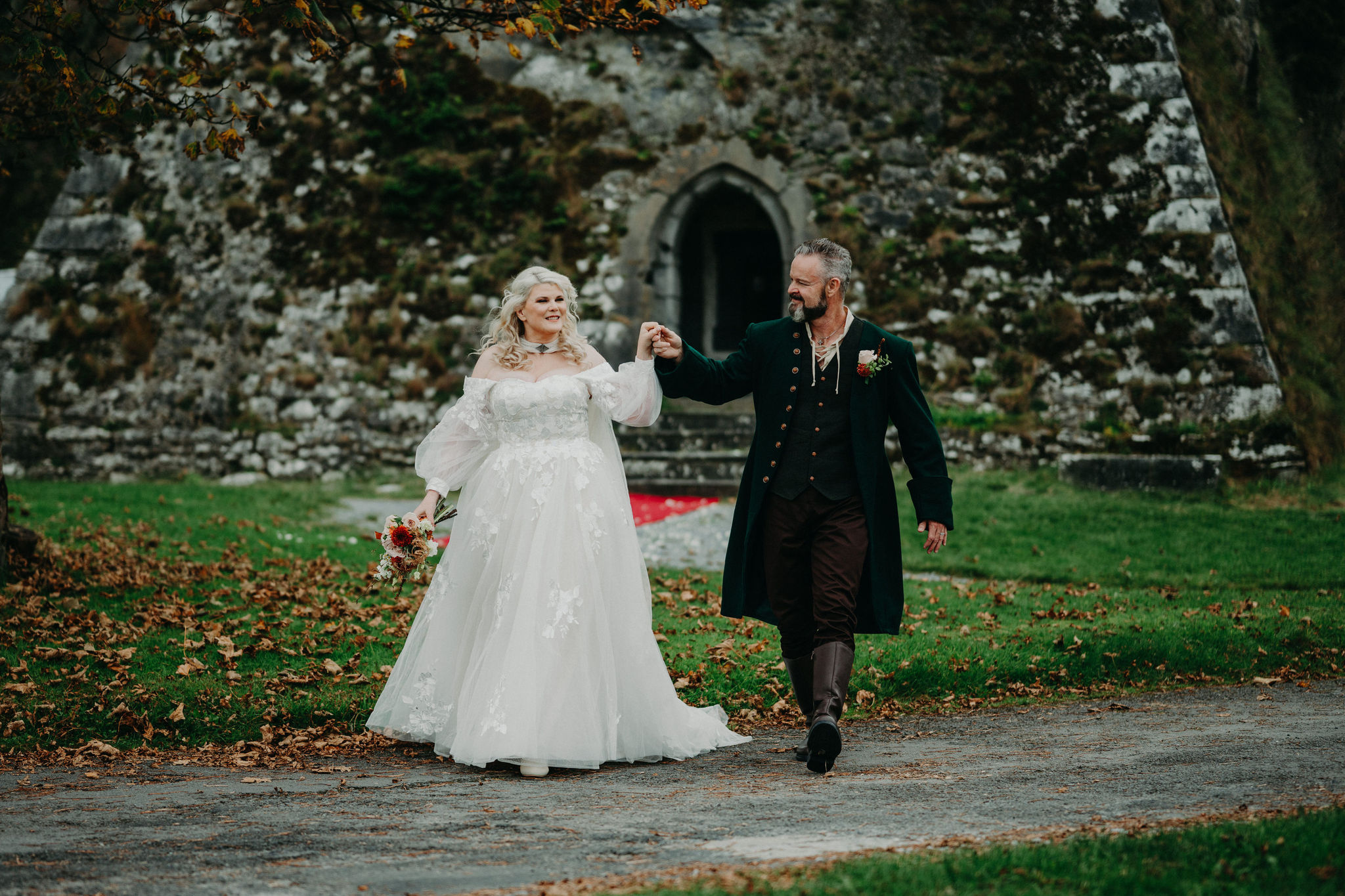 Bride and groom celebrating outside Newtown Castle after getting married in Ireland.