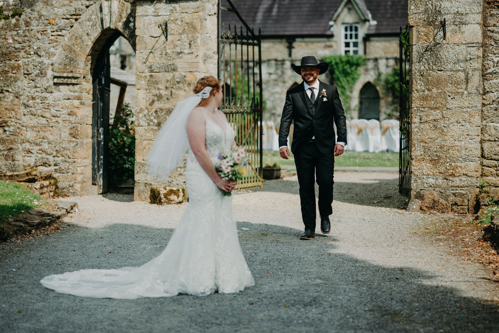 Bride and groom sharing a first look moment at Kinnitty Castle in Ireland before their outdoor wedding ceremony. Description: