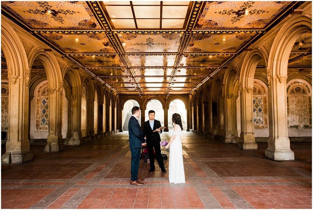 Couple exchanging vows beneath Bethesda Terrace in Central Park New York City