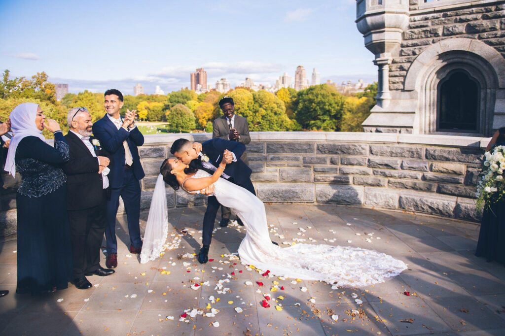 Bride and groom celebrating their wedding at Belvedere Castle in Central Park New York City