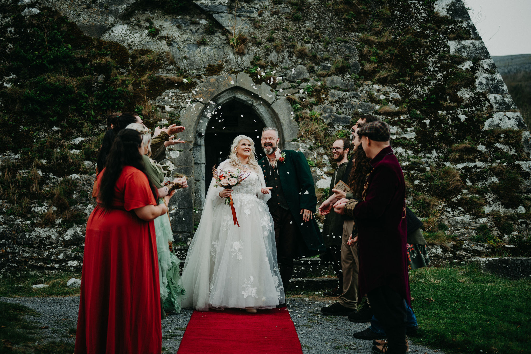 Newlywed couple celebrating outside Newtown Castle after destination elopement wedding in Ireland.