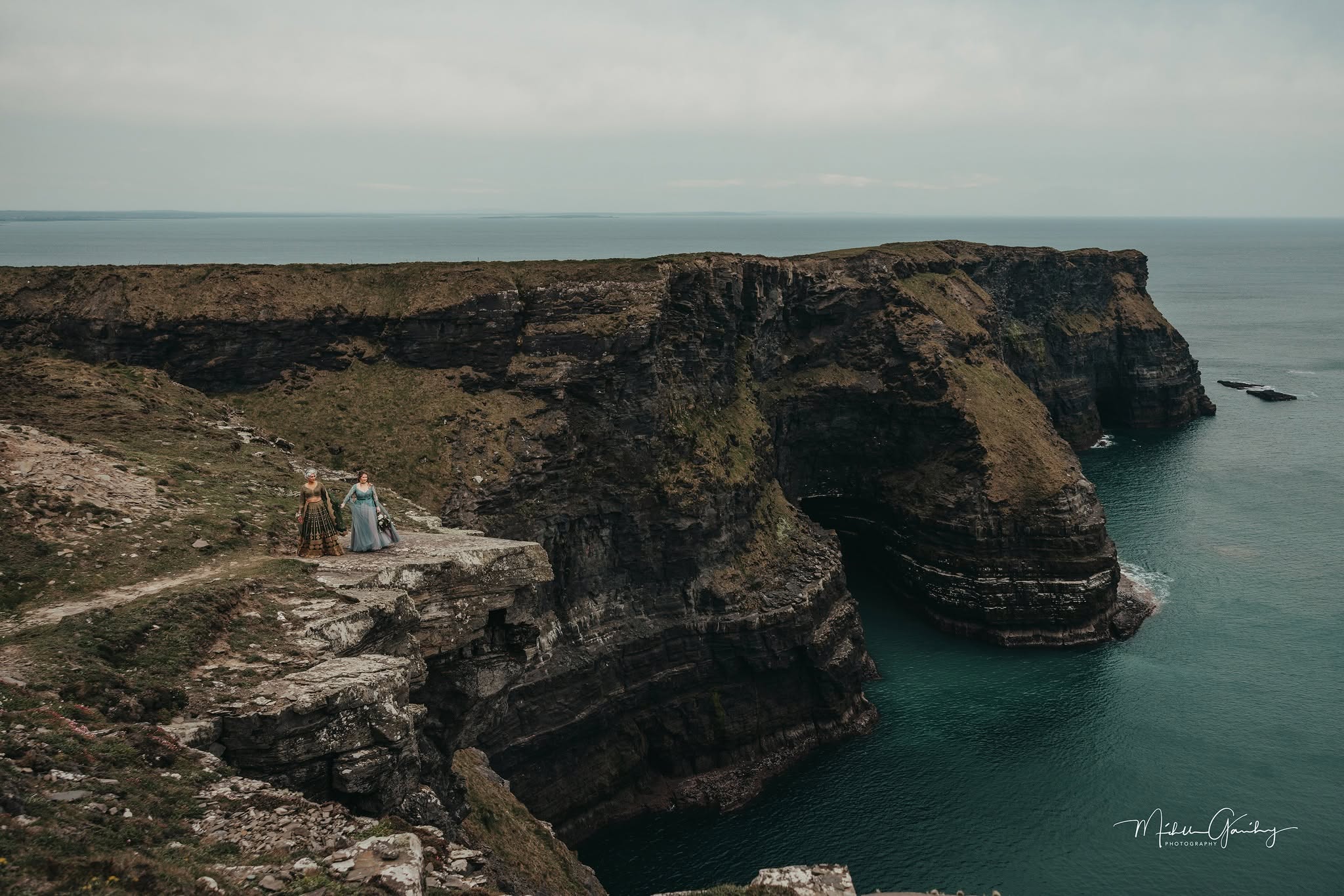Couple eloping on the dramatic Cliffs of Moher coastline in Ireland