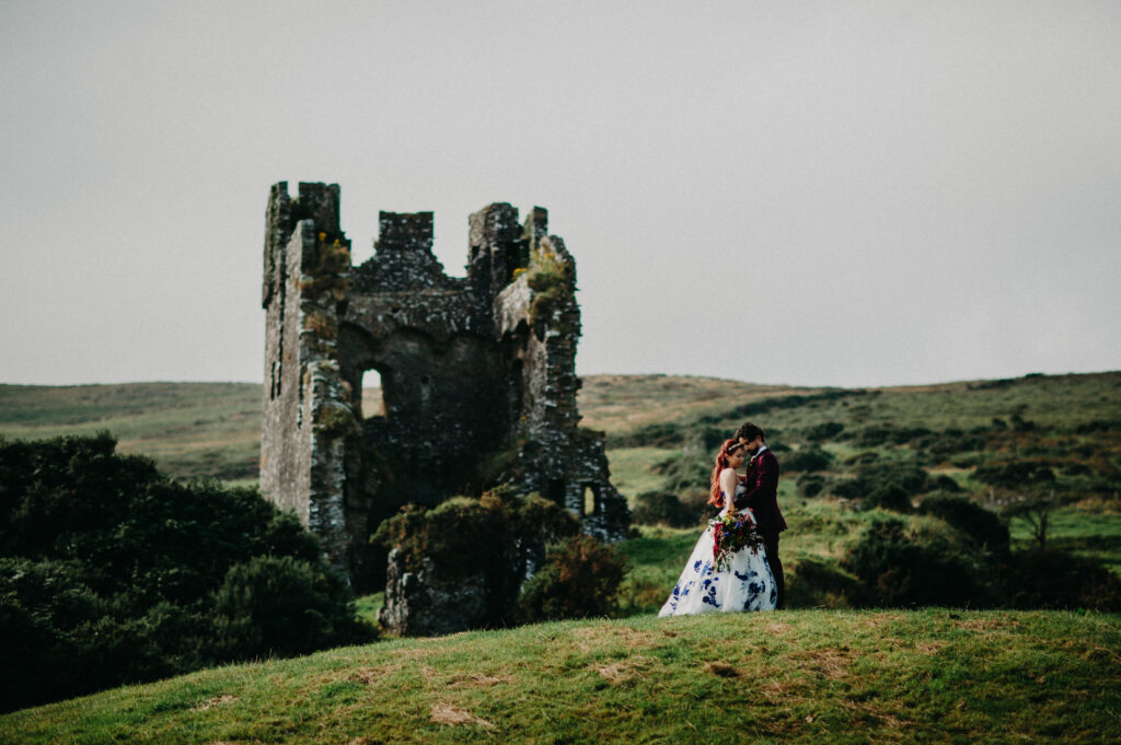 Couple at an Irish castle ruin planned by an Ireland elopement planner